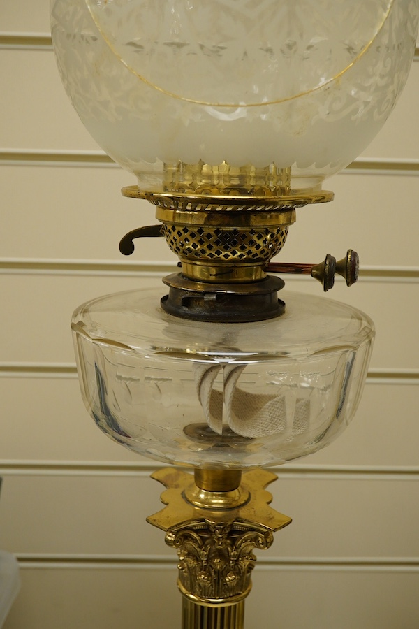 An Edwardian brass Corinthian columned oil lamp, 77cm high including funnel and shade. Condition - column good glass bowl, brass figments and funnel good, shade broken